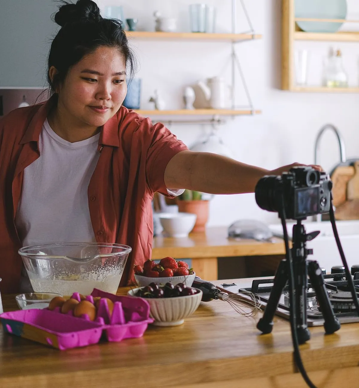 A creator filming a cooking video at home